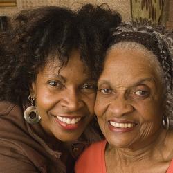 African American lady hugging another African American lady